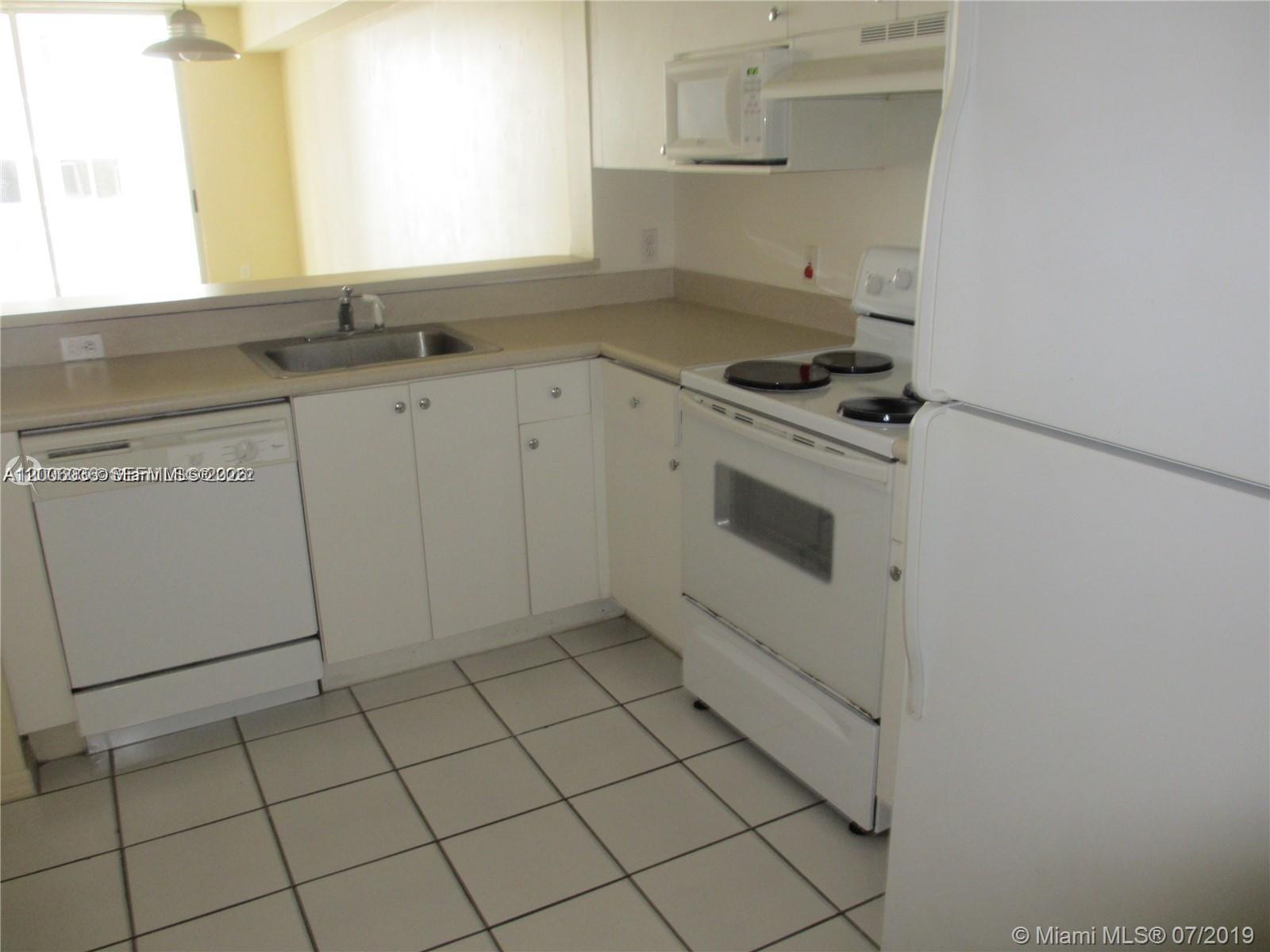 A white kitchen features a sink, dishwasher, electric stove, and white cabinetry — 5091 NW 7th St # 807, Miami FL 33126, MIAMI, FL