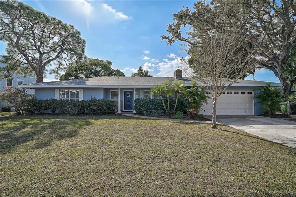 A single-story house with a gray exterior, a two-car garage, and a large front lawn — 1958 MORRIS STREET, SARASOTA, FL