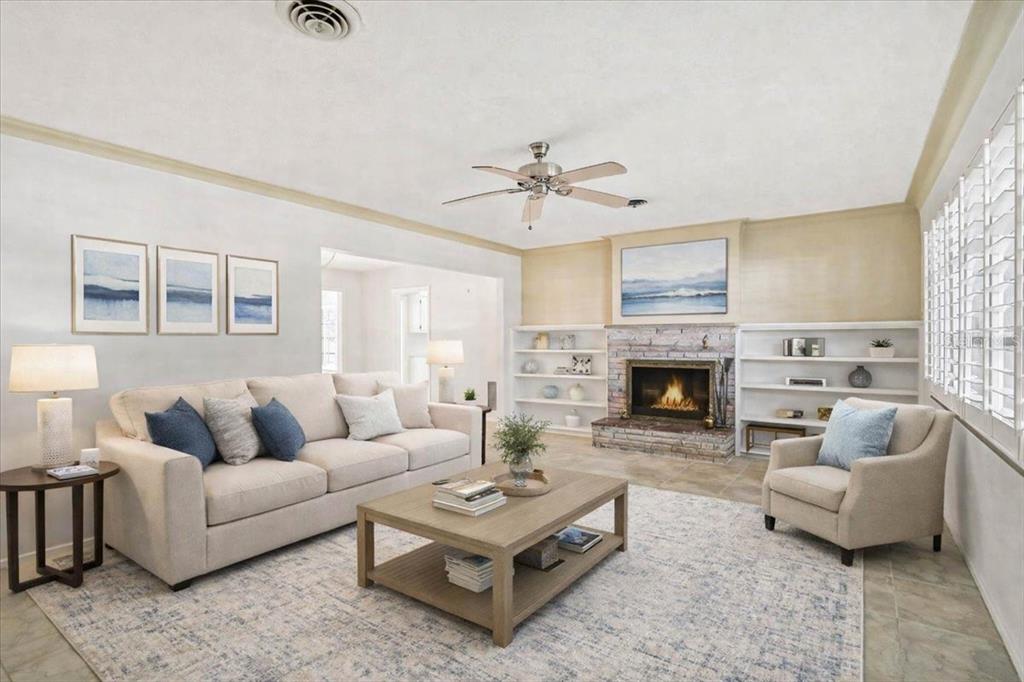 A living room features a fireplace, built-in shelving, a sofa, an armchair, and a coffee table — 1958 MORRIS STREET, SARASOTA, FL