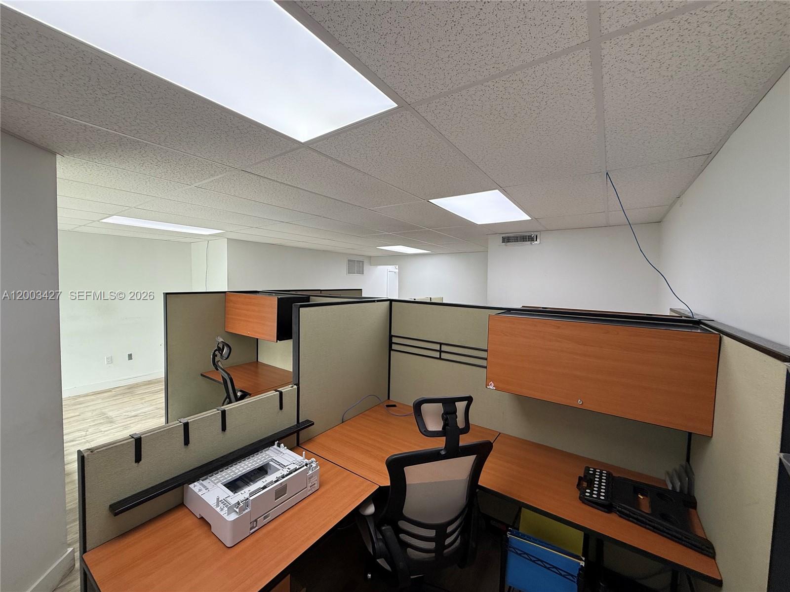 An office space features modular cubicle workstations with wooden desks and overhead storage cabinets — 16155 SW 117th Ave # B18, Miami FL 33177, MIAMI, FL
