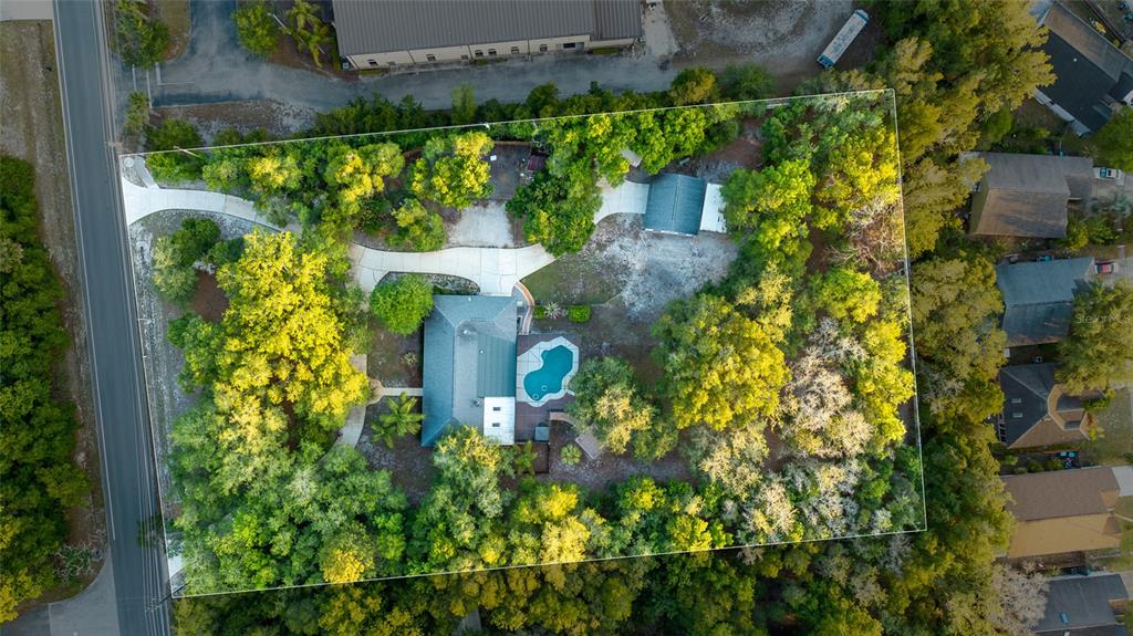 An aerial view shows a house with a pool, driveway, and detached garage on a lot — 330 HAYES ROAD, WINTER SPRINGS, FL