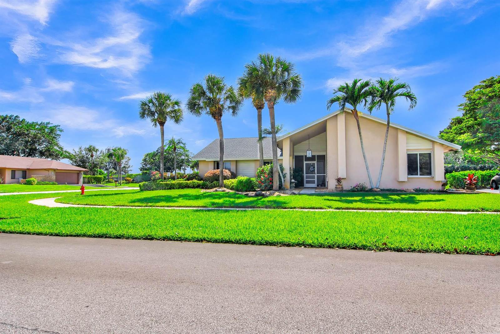 A single-story house with a tan exterior, palm trees, and a green lawn — 18375 104th Terrace S, Boca Raton FL 33498, BOCA RATON, FL