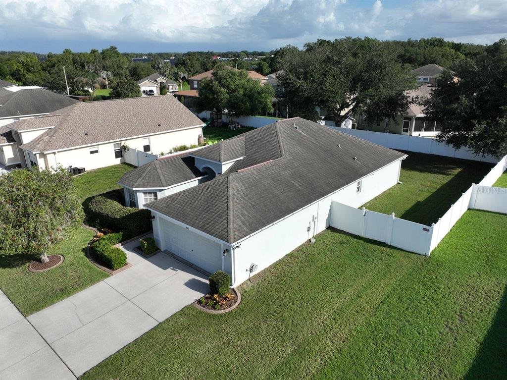 An aerial view shows a single-story house with a gray shingle roof and white exterior — 4693 HARTS BROOK LANE, MULBERRY, FL