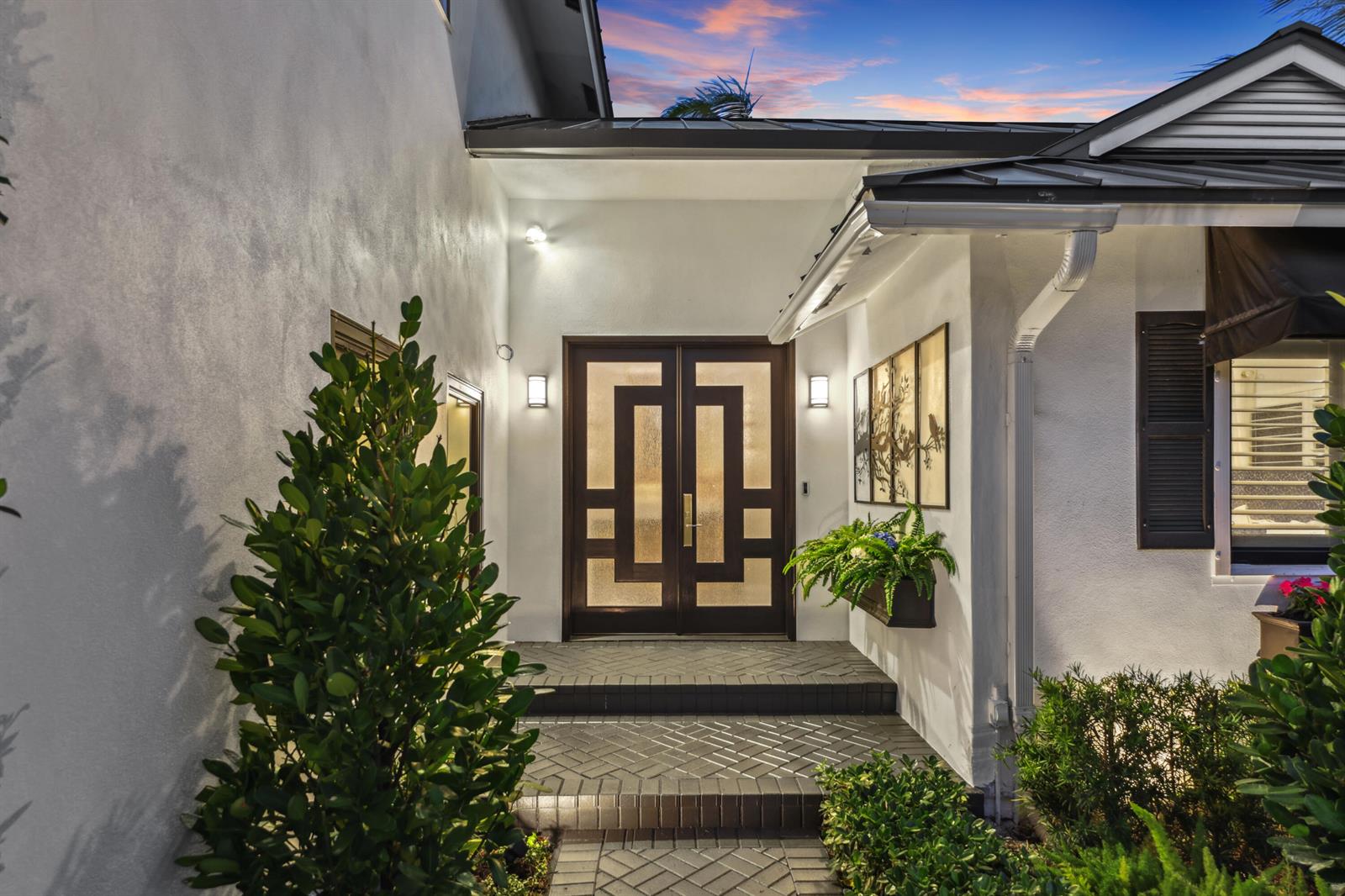 A front entryway features a dark double door with geometric glass panels and brick steps — 125 Marlin Drive, Ocean Ridge FL 33435, OCEAN RIDGE, FL