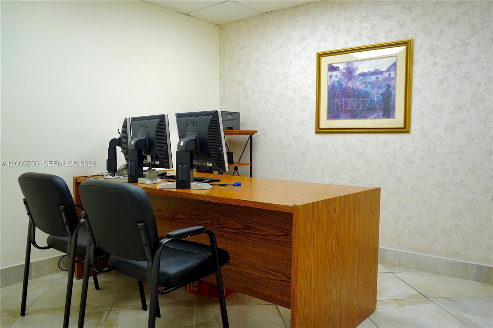 An office room features a wooden desk with two computer monitors and two black chairs — 150 Westward Dr # 2, Miami Springs FL 33166, MIAMI SPRINGS, FL
