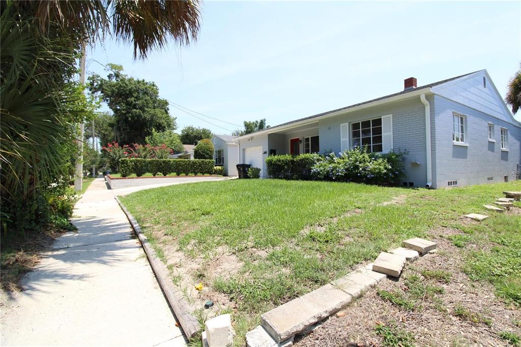 A single-story light blue house with a brick exterior and a front lawn — 1639 OAKMONT LANE, ORLANDO, FL