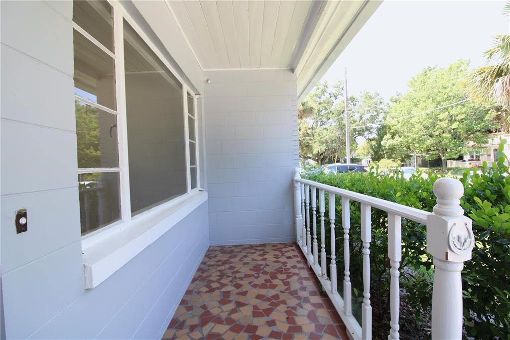 A covered porch features a mosaic tile floor, white railings, and light blue block walls — 1639 OAKMONT LANE, ORLANDO, FL