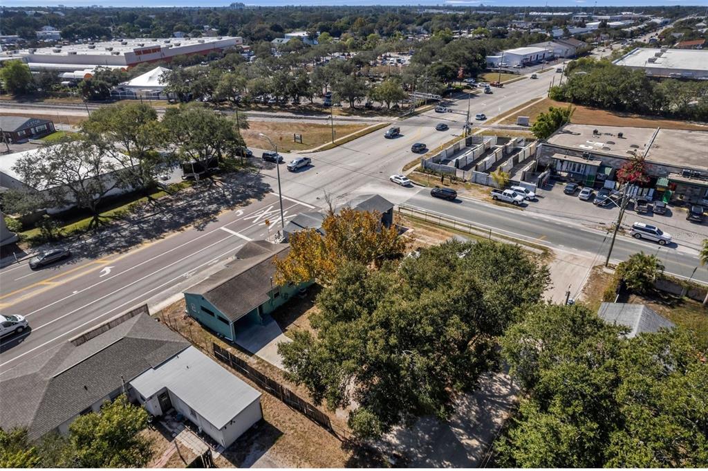 An aerial view shows a residential property with trees near a busy street intersection — 2169 & 2179 22ND AVENUE N, ST PETERSBURG, FL