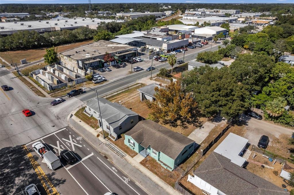 An aerial view shows a residential street with houses, a commercial building, and a road — 2169 & 2179 22ND AVENUE N, ST PETERSBURG, FL
