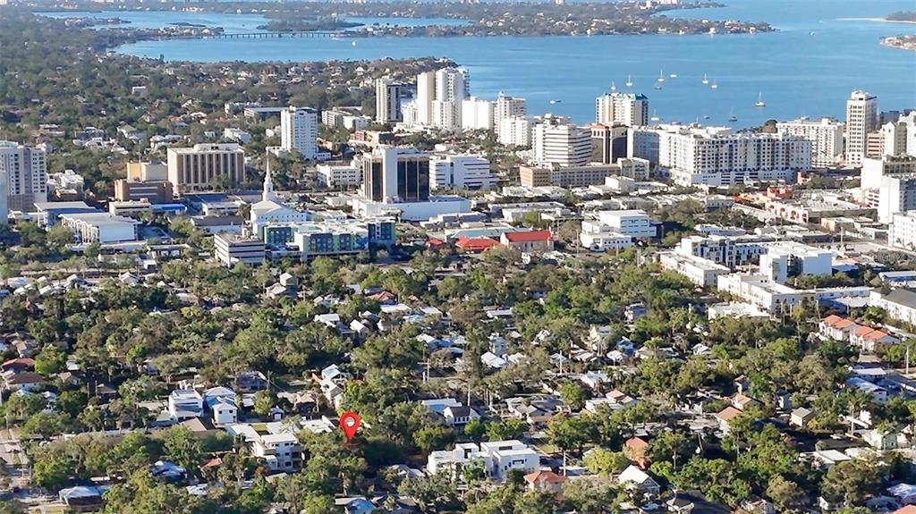 An aerial view shows a residential neighborhood with a red location pin in the foreground — 1721 8TH STREET, SARASOTA, FL