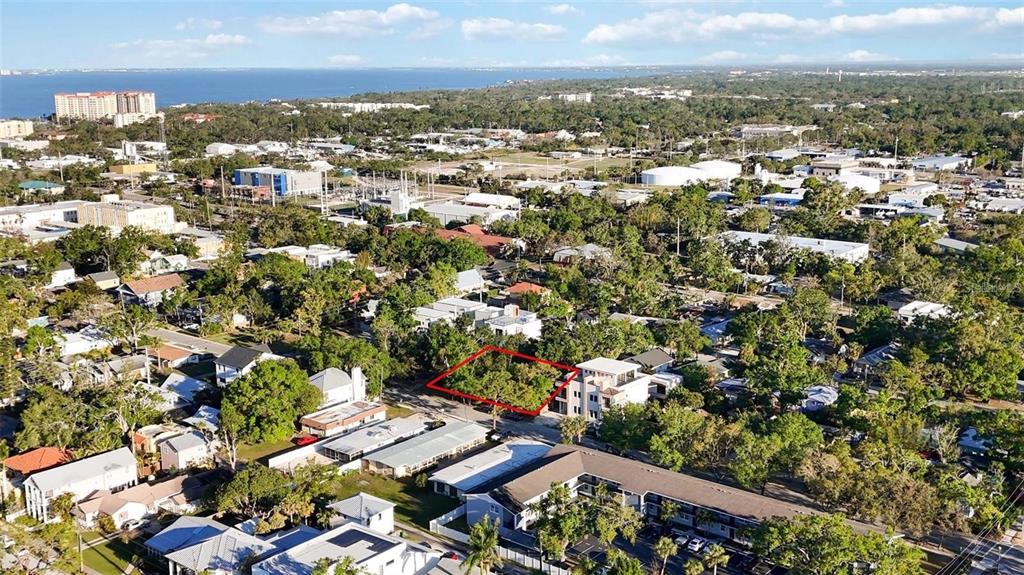 An aerial view shows a vacant lot outlined in red within a residential neighborhood — 1721 8TH STREET, SARASOTA, FL