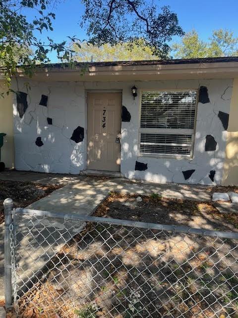 The exterior of a single-story house features a light-colored stone facade with dark accent patches — 734 SW 8th Street, Dania Beach FL 33004, DANIA BEACH, FL