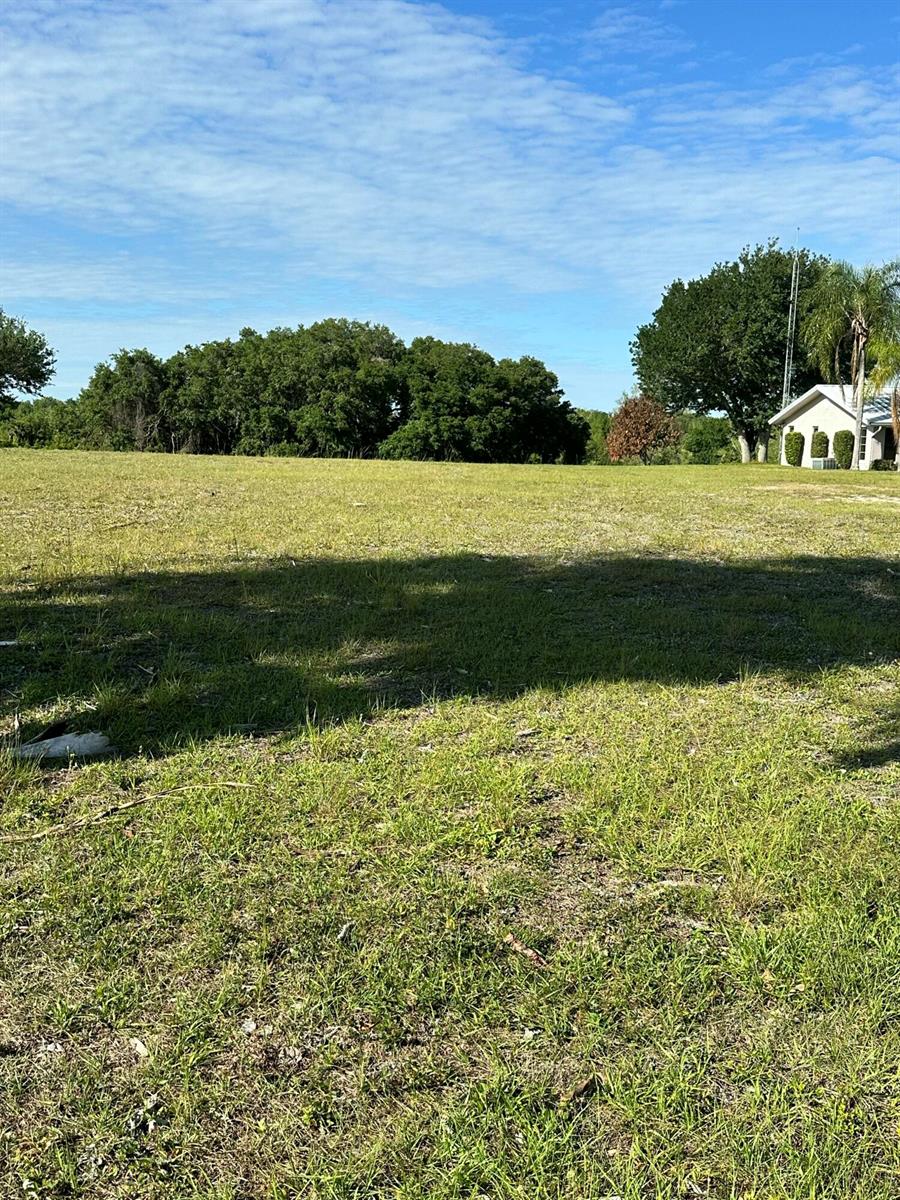 A grassy, open field with a line of trees and a small building in distance — 13364 SW 144th Parkway, Okeechobee FL 34974, OKEECHOBEE, FL