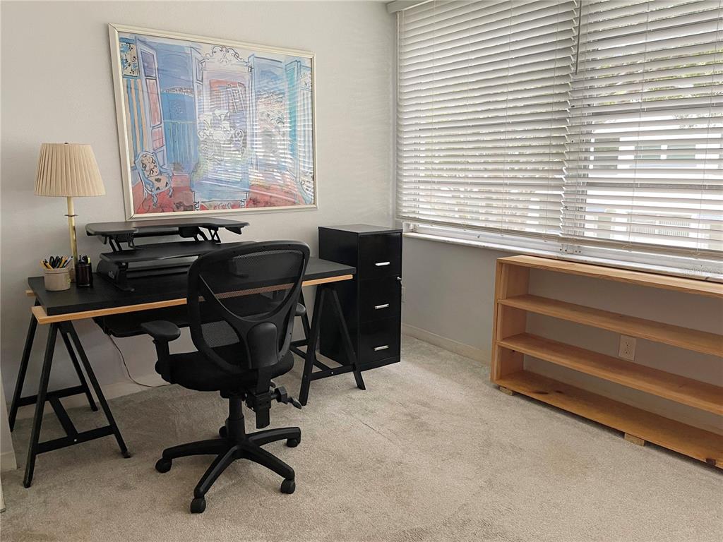 A home office features a desk with a chair, a filing cabinet, and a bookshelf — 5880 38TH AVENUE N UNIT 206, ST PETERSBURG, FL