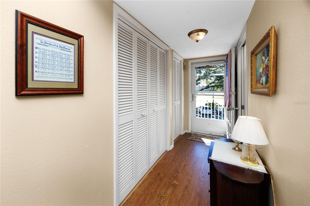 A kitchen with white cabinets, stainless steel appliances, granite countertops, and a mosaic tile backsplash — 2440 WORLD PARKWAY BOULEVARD UNIT 38, CLEARWATER, FL