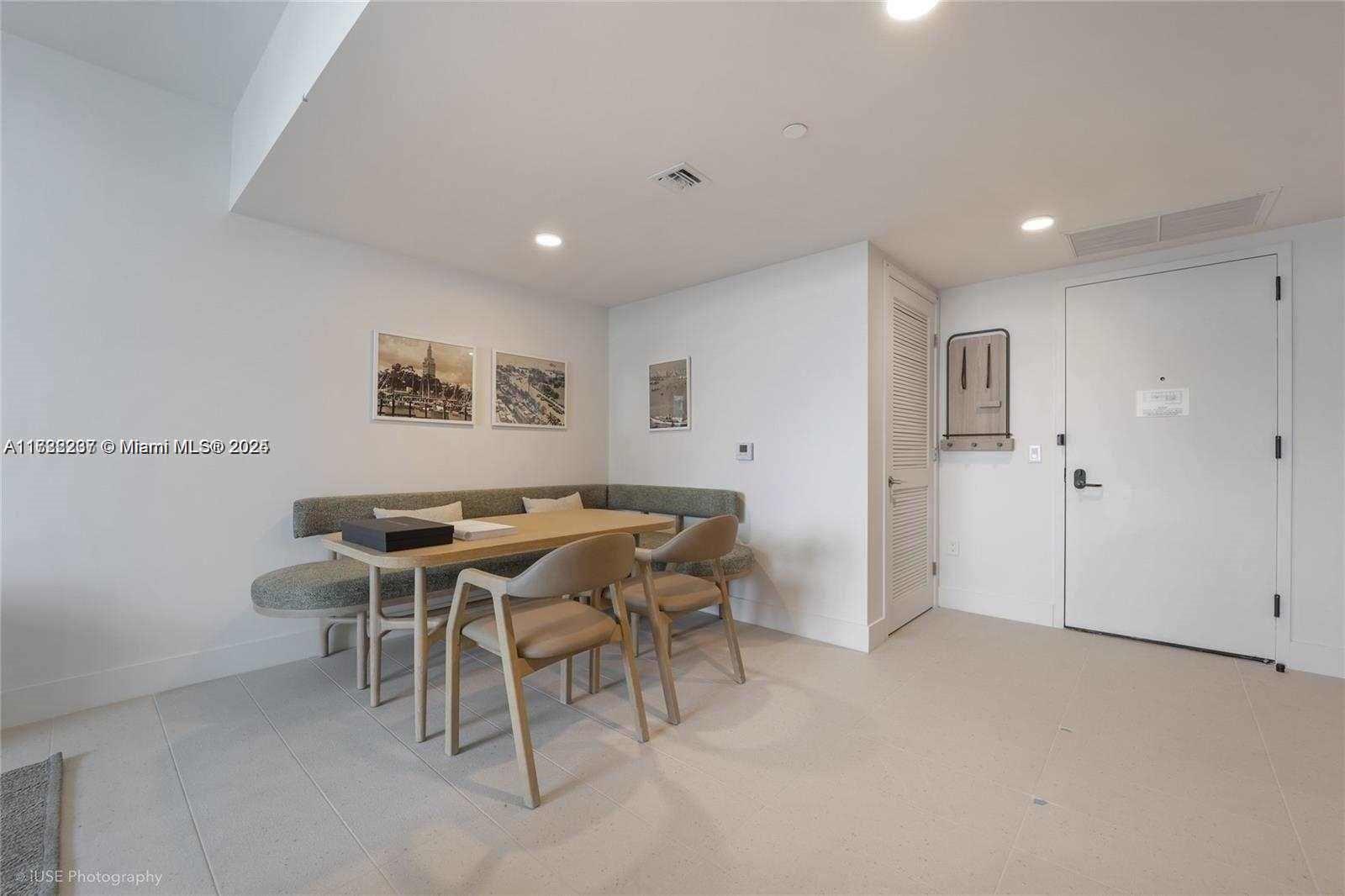 A dining area features a corner banquette, a wooden table, and two modern chairs — 159 NE 6 # 3913, Miami FL 33132, MIAMI, FL