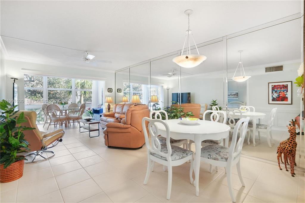 A living and dining area features tiled floors, mirrored walls, and large windows — 1501 S Ocean Boulevard # 214, Pompano Beach FL 33062, POMPANO BEACH, FL
