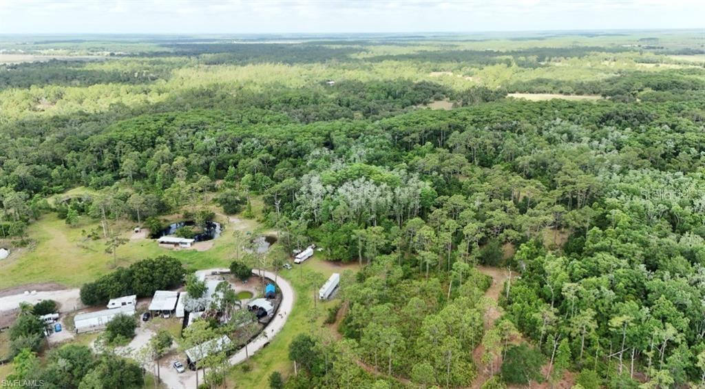 An aerial view shows a rural property with several mobile homes, outbuildings, and small ponds — 1375 W ASH ROAD, LABELLE, FL