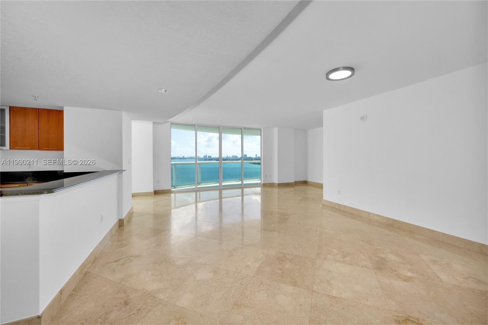 A modern living room features a large sectional sofa, marble coffee table, and floor-to-ceiling windows — 1800 N Bayshore Dr # 1901, Miami FL 33132, MIAMI, FL