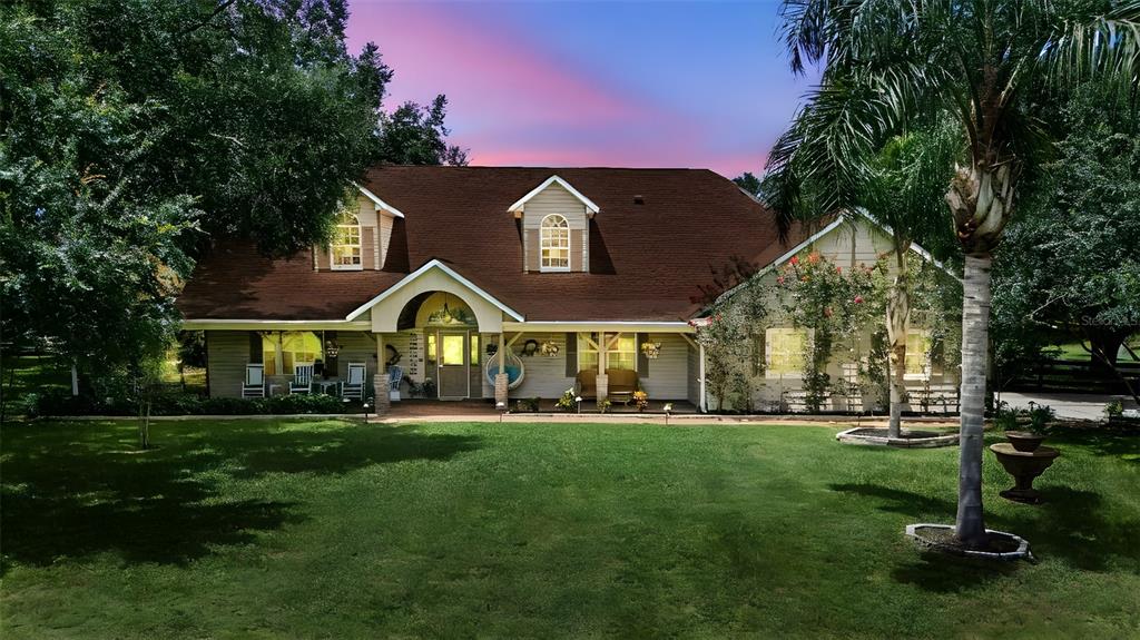 An aerial view of a house with a brown roof, front porch, and two palm trees — 32137 WOLF BRANCH LANE, SORRENTO, FL