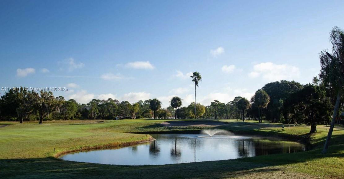 A small pond with a fountain sits in the foreground of a sunny golf course — 7004 Mona Avenue, Sebring FL 33872, SEBRING, FL