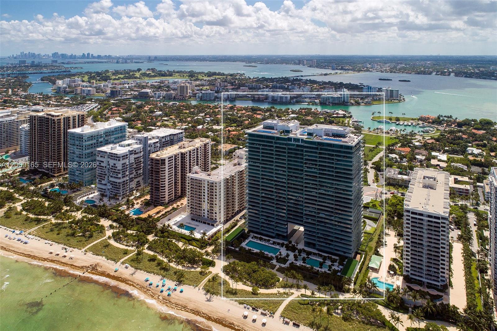 An aerial view shows a tall residential building on a beach with multiple swimming pools — 10201 Collins Ave # 503, Bal Harbour FL 33154, BAL HARBOUR, FL