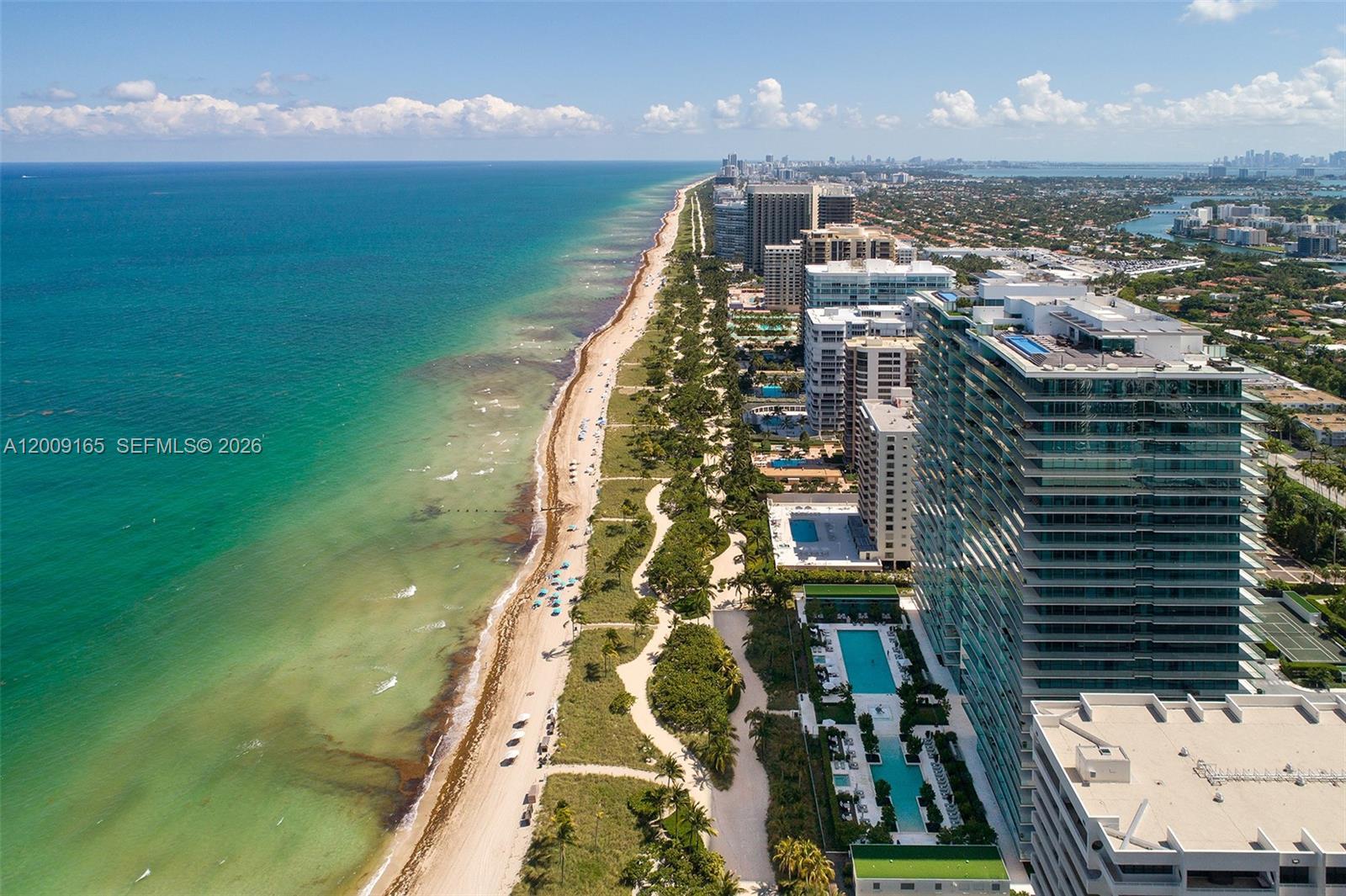 An aerial view shows a sandy beach bordering the ocean next to several high-rise buildings — 10201 Collins Ave # 503, Bal Harbour FL 33154, BAL HARBOUR, FL