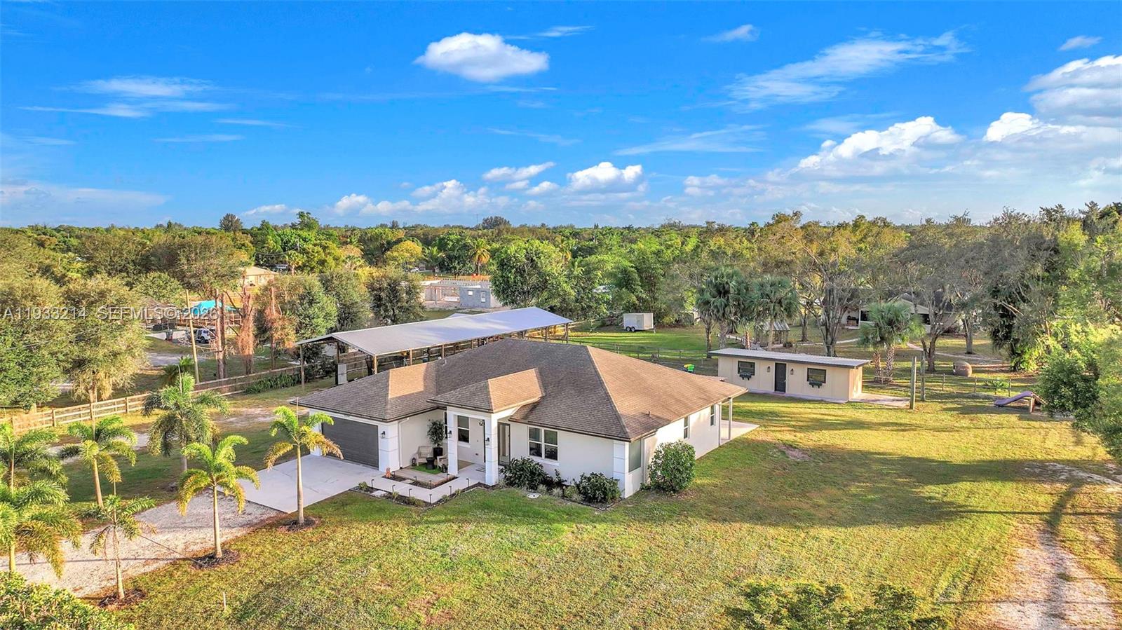 An aerial view shows a single-story house with a garage, carport, and detached outbuilding — 17844 N 38th Rd N, Loxahatchee FL 33470, LOXAHATCHEE, FL