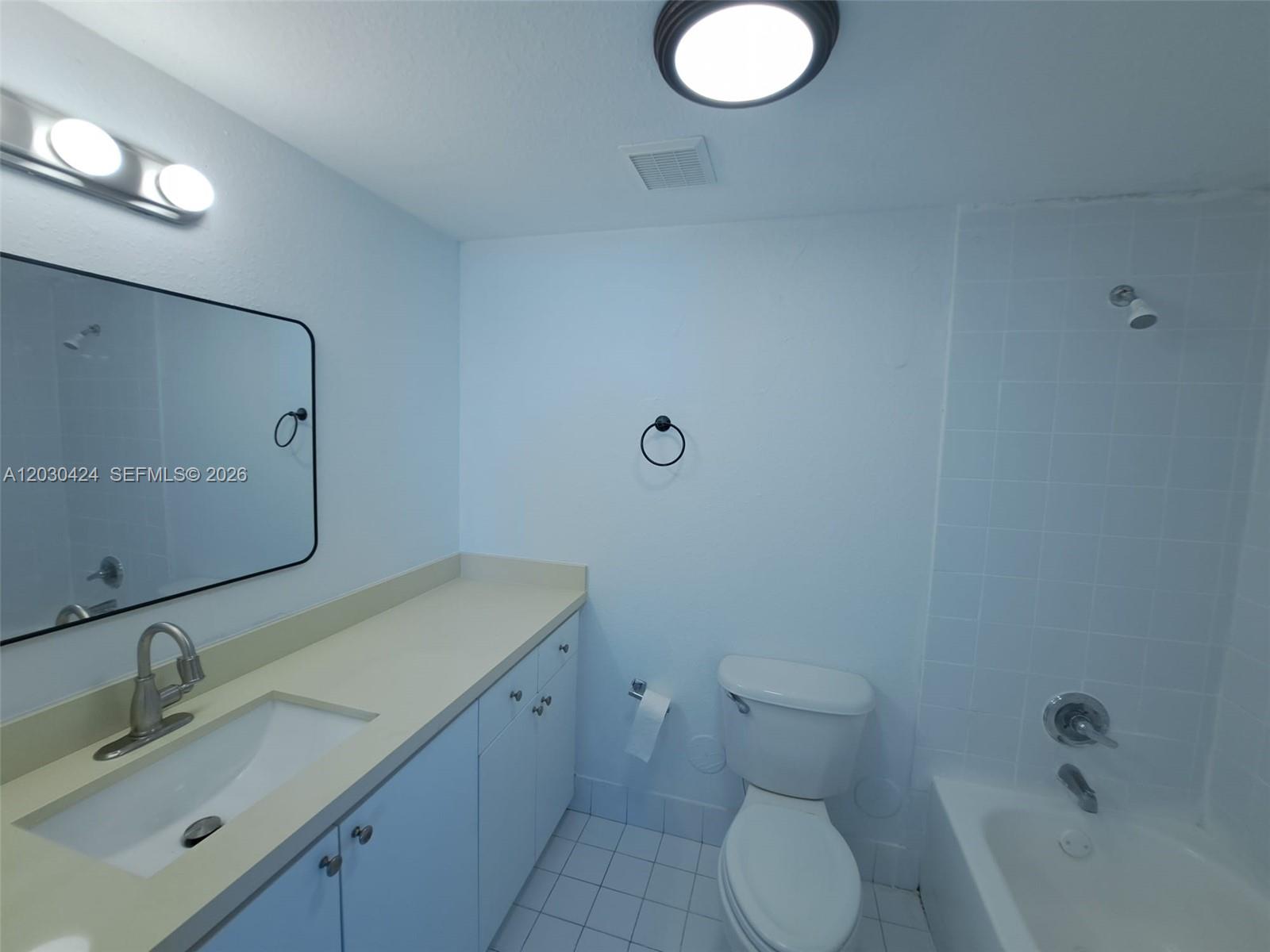 A bathroom features a vanity with a sink, a toilet, and a shower-tub combination — 120 SW 8th Ave # 903, Miami FL 33130, MIAMI, FL