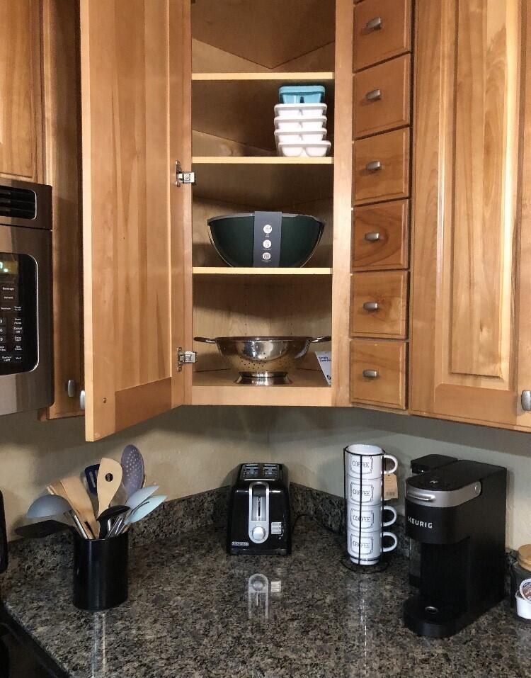 A kitchen corner features wood cabinets, granite countertops, a toaster, and a coffee maker — 1420 Ocean Way # 29a, Jupiter FL 33477, JUPITER, FL