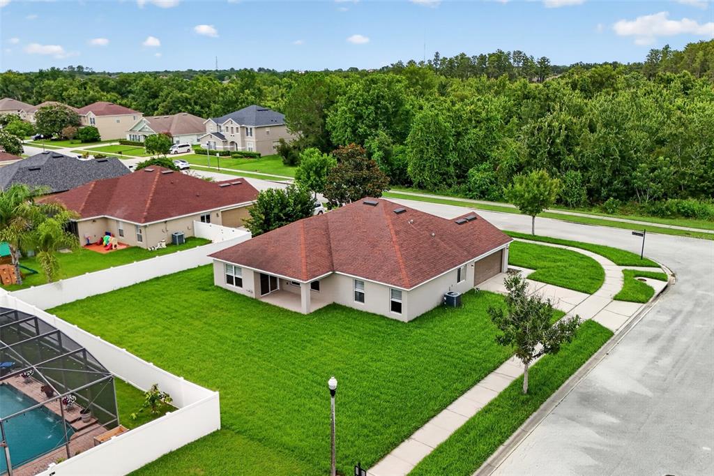 An aerial view shows a single-story house with a red roof and a large lawn — 356 BLACK SPRINGS LANE, WINTER GARDEN, FL