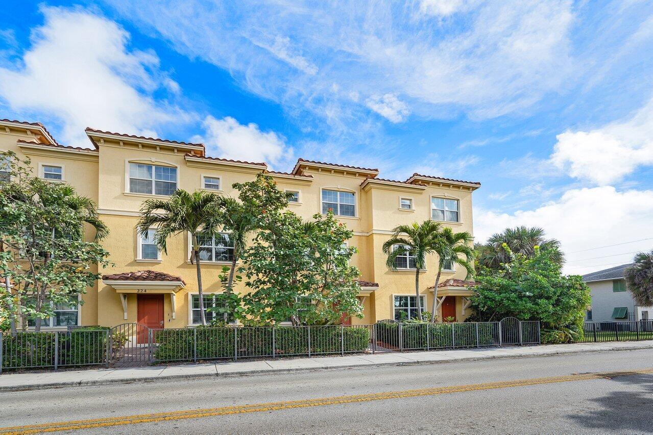 A three-story yellow townhouse complex with palm trees and a metal fence in front — 224 S Federal Highway # 4, FL 33460, FL
