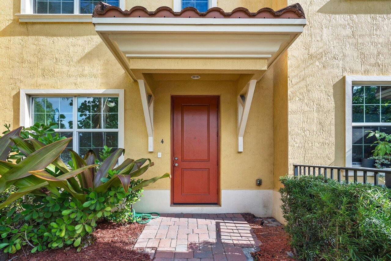 A red front door with the number four sits under a small porch overhang — 224 S Federal Highway # 4, FL 33460, FL