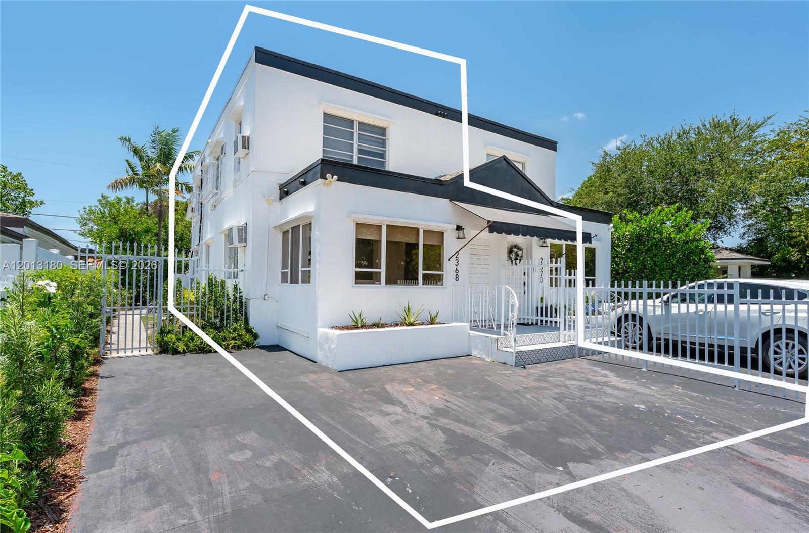A two-story white building with a black trim and a paved front parking area — 2368 SW 26th St # A, Miami FL 33133, MIAMI, FL