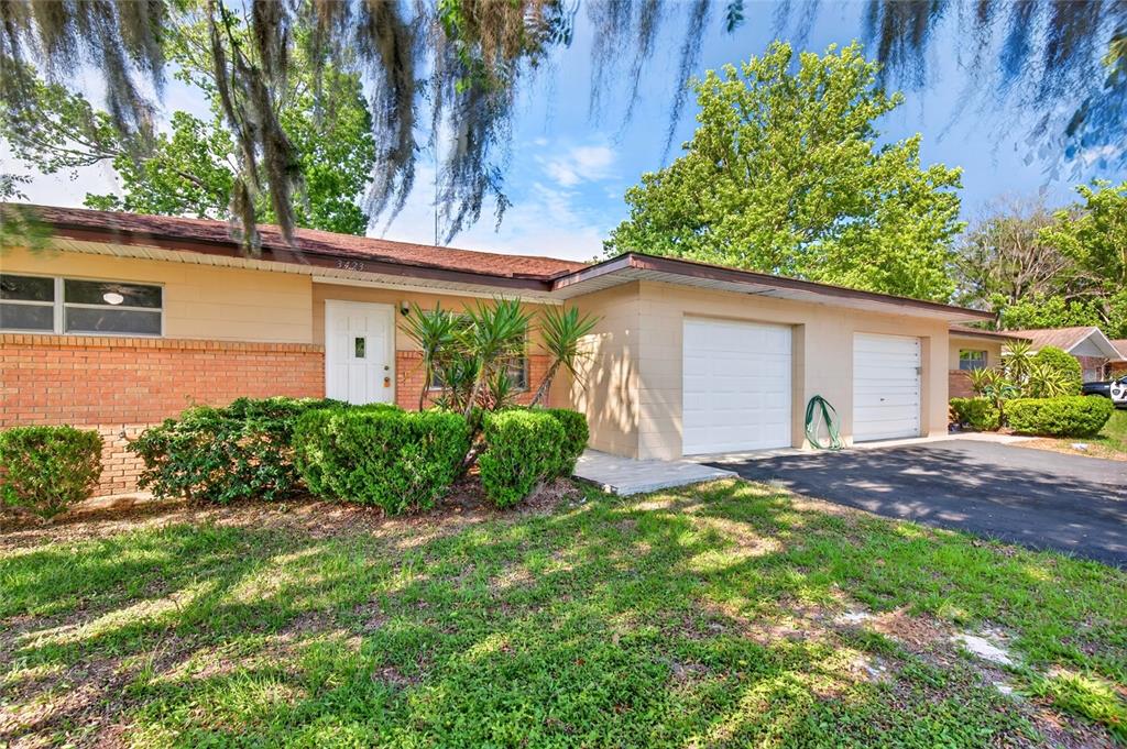 A single-story house with a brick and tan exterior, two garage doors, and a front lawn — 3423 SW 27TH STREET, OCALA, FL