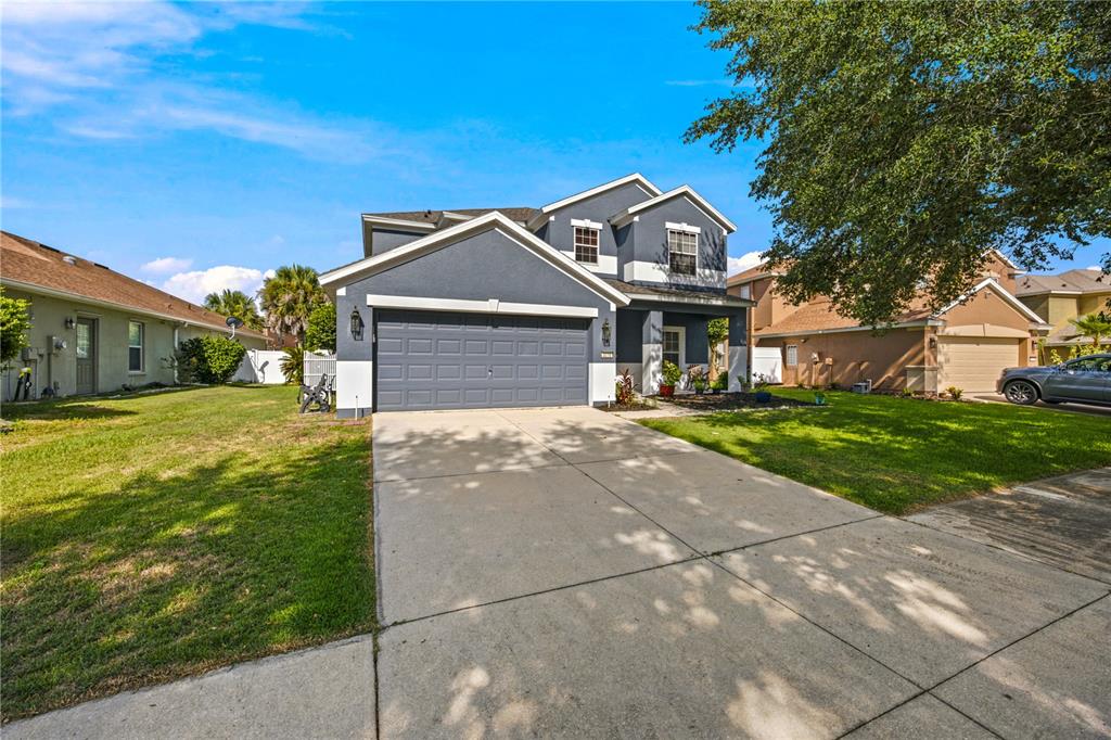 A two-story house with a blue exterior, a two-car garage, and a concrete driveway — 3970 SW 51ST TERRACE, OCALA, FL