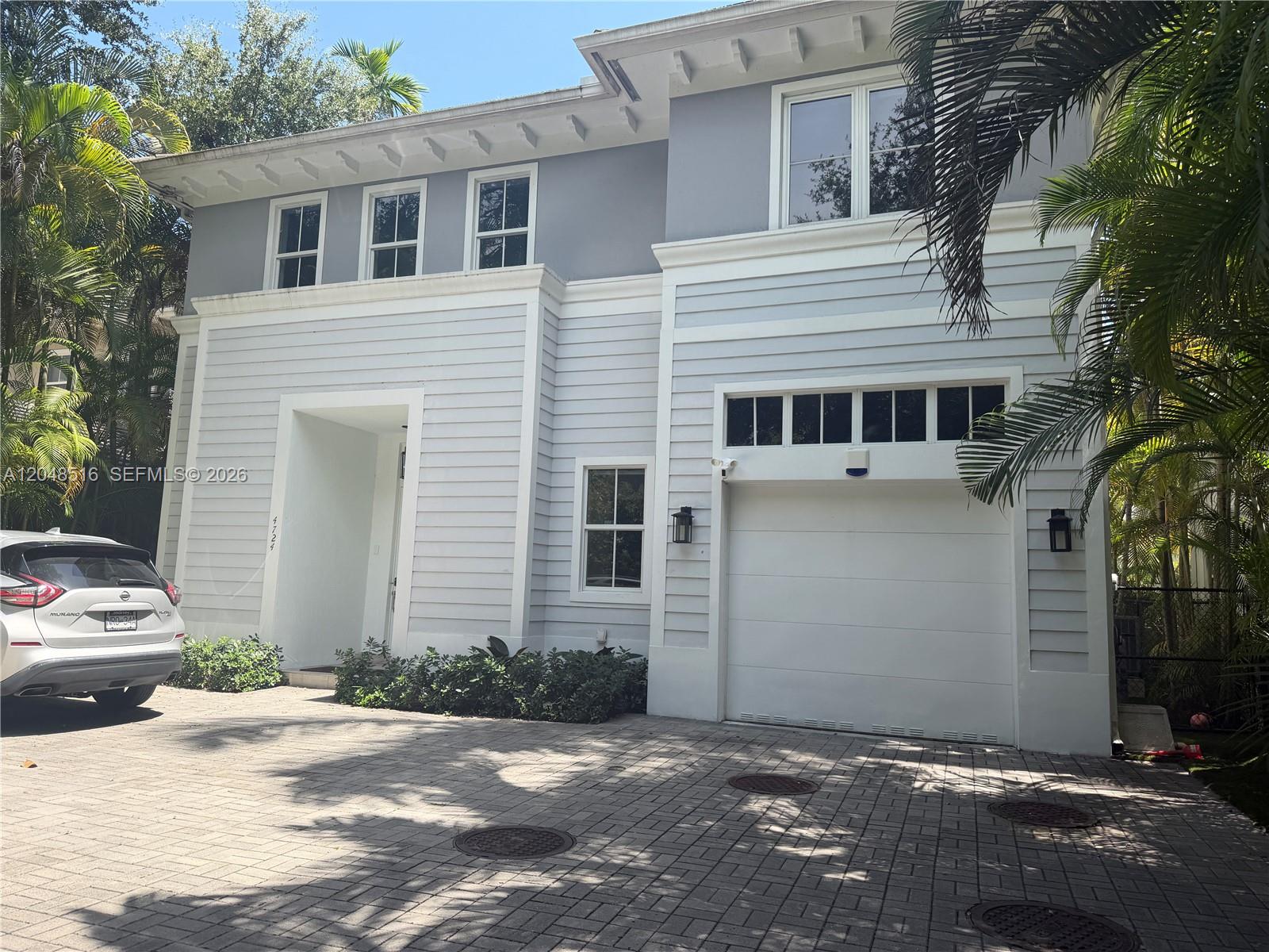 A two-story house with light gray siding, a white garage door, and a paved driveway — 4724 SW 72nd ST, Miami FL 33143, MIAMI, FL