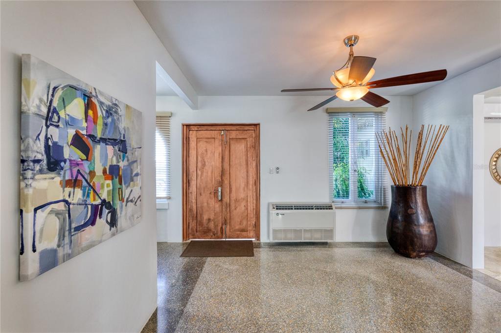 A spacious living area features terrazzo floors, arched transitions, and multiple ceiling fans — 3 PACIFIC PLACE STREET, SAN JUAN, PR