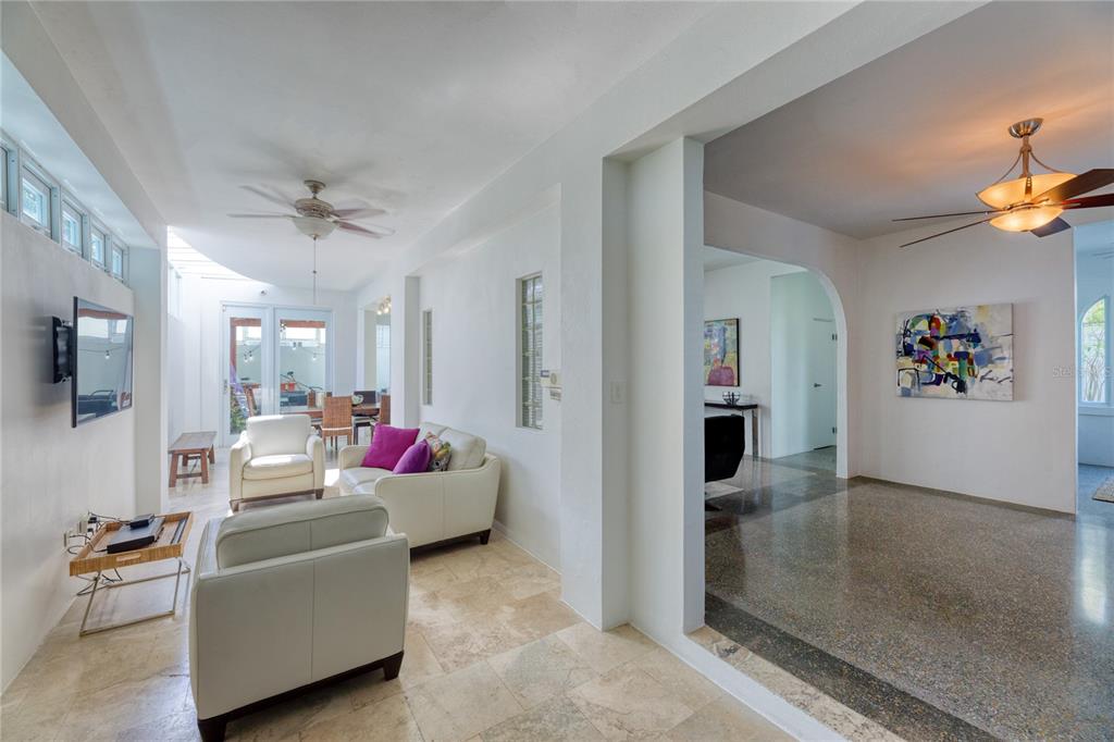 A living room with tile floors, white furniture, and an adjacent dining area with glass doors — 3 PACIFIC PLACE STREET, SAN JUAN, PR