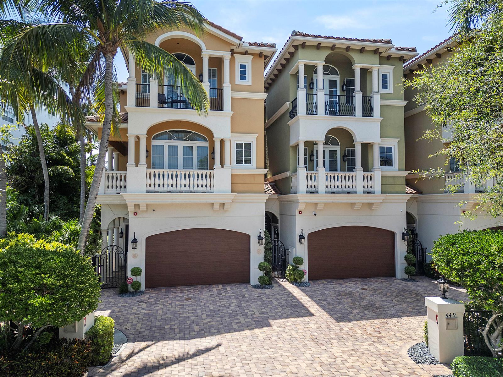 The exterior view shows three townhouses with arched garage doors and a paved driveway — 449 NE 19th Avenue, Deerfield Beach FL 33441, DEERFIELD BEACH, FL