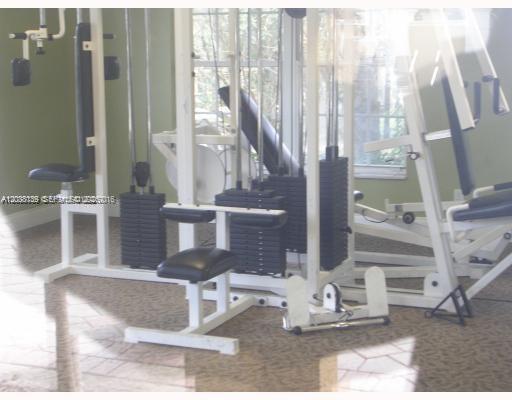 A multi-station weight training machine sits in a room with light-colored walls and flooring — POMPANO BEACH, FL