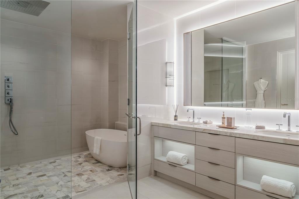 A modern bathroom features a glass-enclosed shower, a freestanding tub, and a double vanity — Ocean Drive FOUR SEASONS PRIVATE RESIDENCES UNIT 6401, RIO GRANDE, PR