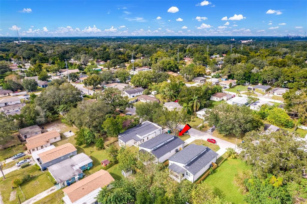 An aerial view shows a residential neighborhood with several houses and a red arrow — 3717 E CLIFTON STREET, TAMPA, FL