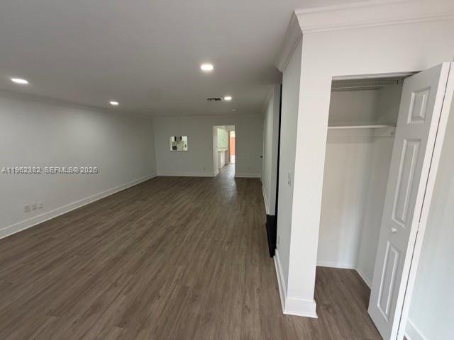 A spacious room with light wood-look flooring, recessed lighting, and an open closet — 13725 SW 84th St # C, Miami FL 33183, MIAMI, FL