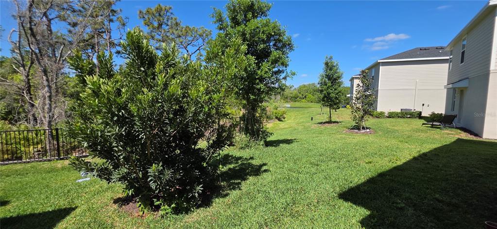 A two-story house with light gray siding, a gray garage door, and a paved driveway — 13961 LILAC SKY TERRACE, BRADENTON, FL