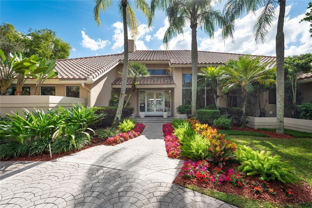 A paved walkway leads to the front entrance of a house with a tile roof — 3190 Willow Lane, Weston FL 33331, WESTON, FL