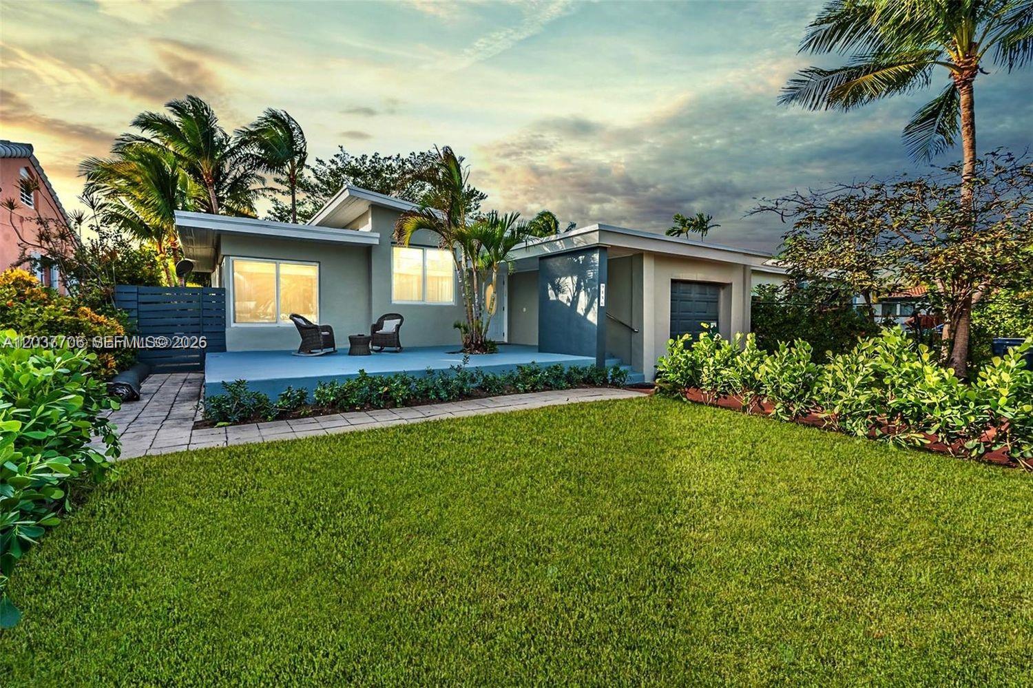 A single-story house with a blue patio, palm trees, and a green lawn — 9156 Froude Ave, Surfside FL 33154, SURFSIDE, FL