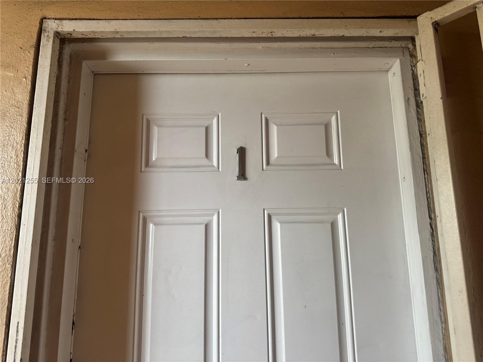 A white, four-panel door features a silver number one mounted in the center — 11 SW 32nd Ave # 1, Miami FL 33135, MIAMI, FL