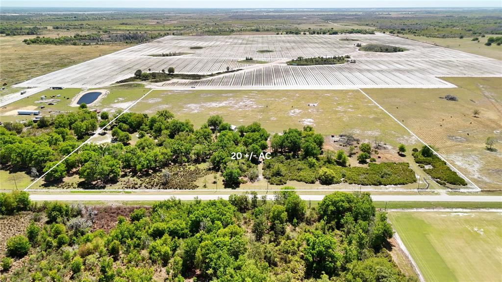 An aerial view shows a rectangular 20-acre plot of land featuring trees and open fields — AVON PARK CUTOFF ROAD, FORT MEADE, FL