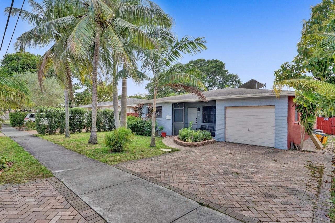 A single-story house with a brick driveway, a one-car garage, and palm trees — 208 SW 2nd Ave, Hallandale Beach FL 33009, HALLANDALE BEACH, FL